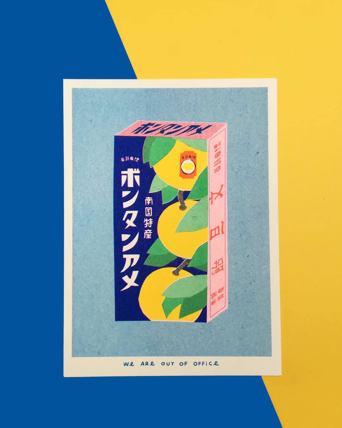 Japanese Candy Box risograph print by We Are Out of Office – vibrant pop-art style illustration of a vintage Japanese bonbon box with yellow fruit and kanji, printed with soy ink on 300g Biotop paper in the Netherlands.