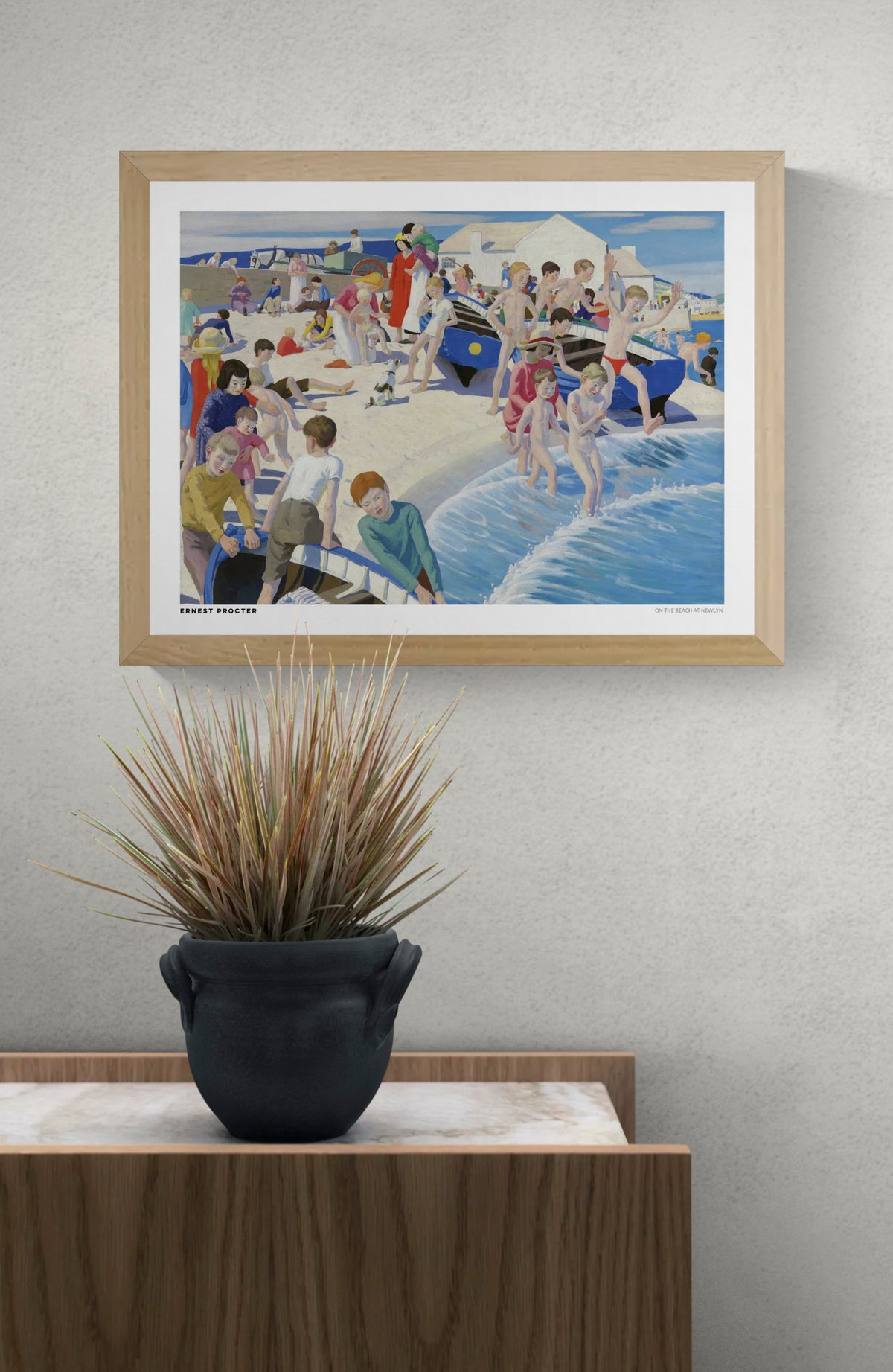 On the Beach at Newlyn by Ernest Procter, colourful British seaside painting with children swimming, families on the sand and blue fishing boats. Horizontal coastal artwork reproduced as a digital wall art print.
