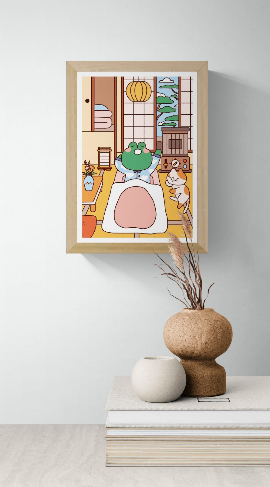Bobby in Bed by Niniwanted, a colorful A5 digital art print featuring a cute green frog tucked into bed beside a playful cat in a Japanese-style bedroom. Kawaii wall art in soft pastel colors.