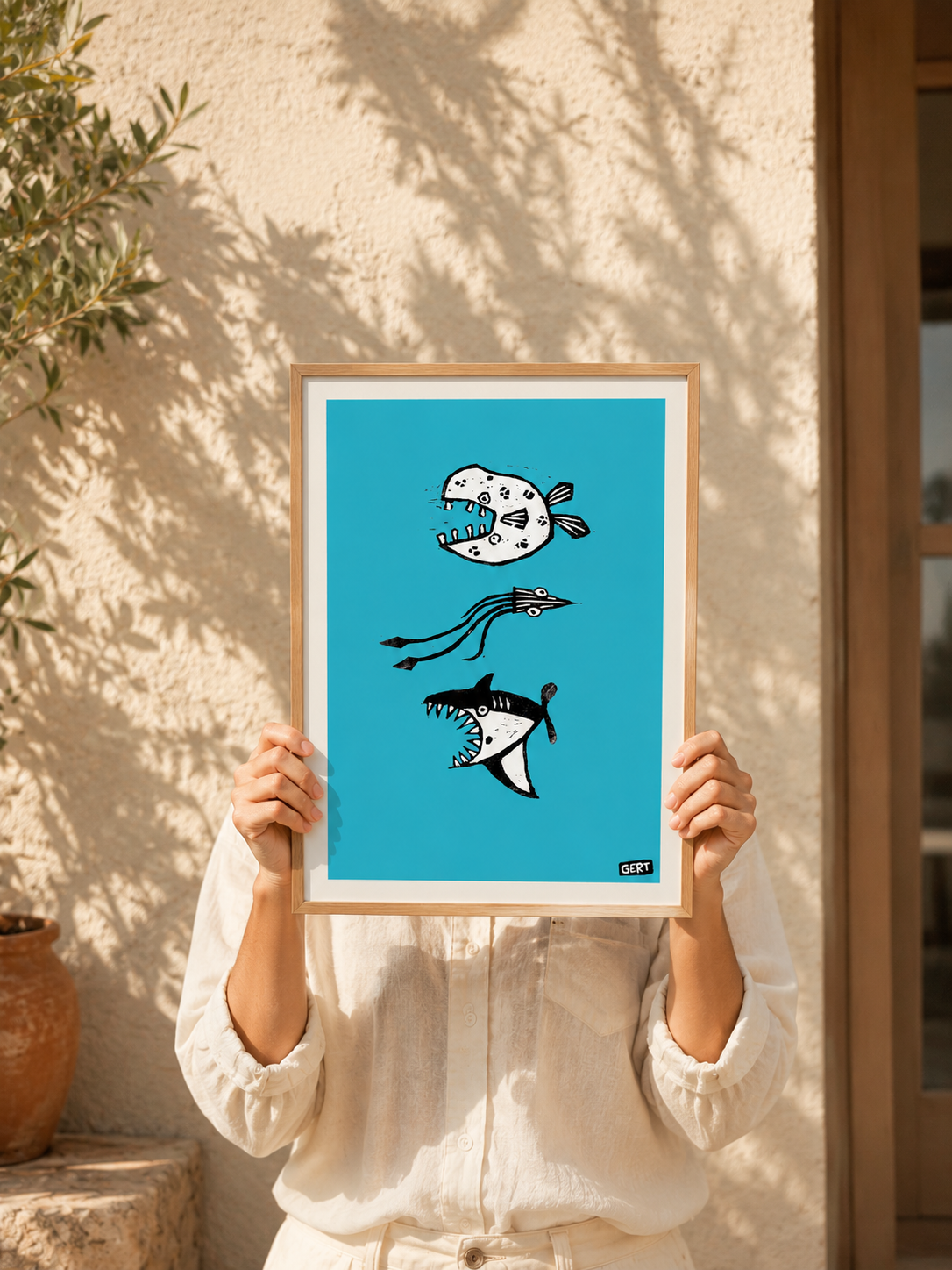 3 Fish (lino) by Gert Paenen, original linocut-style fish illustration reproduced as a digital art print with black graphic fish on a bright blue background.