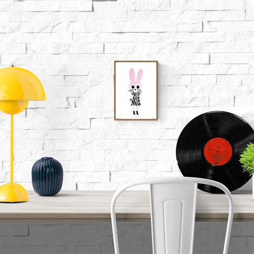 Playful handprinted screenprint of a pink rabbit with a black dress and boots, whimsical and minimal illustration by Plumo – A5 art print made in Belgium.