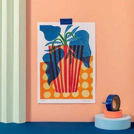 Colorful risograph print of a red-striped pot with bold blue and green foliage on an orange polka-dot background – Popcorn pot by Teresa Rego, A5 limited edition art print made in Portugal.