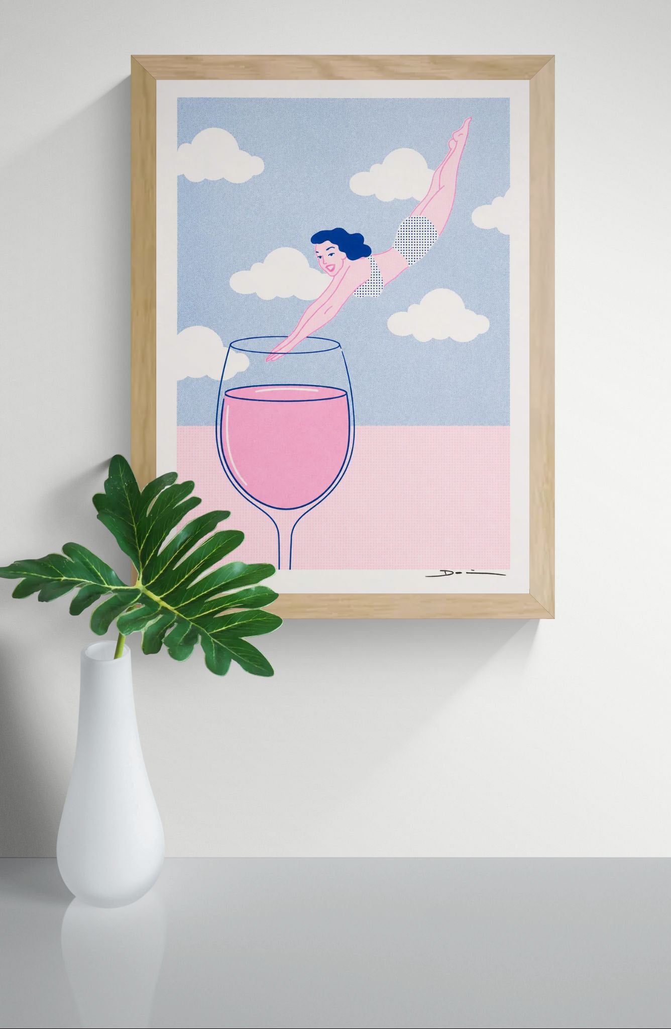 Playful risograph print of a woman diving into a glass of pink wine beneath white clouds, illustrated in pastel pink and blue with a contemporary graphic style, ideal for kitchen, dining room, or modern home decor.