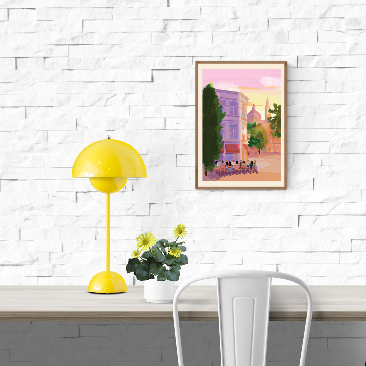 Digital A4 art print titled Terrasjes in Antwerpen by Valeria Maggiani, showing people enjoying a terrace in Antwerp at sunset with pink skies and cathedral in the background. Printed in Belgium under the artist’s supervision. Ideal for urban and travel-inspired home decor.