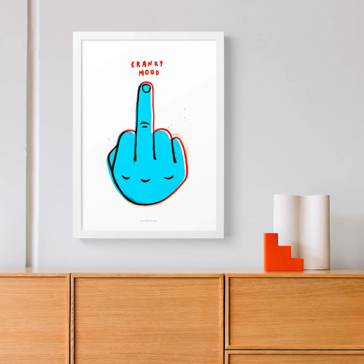 Colorful pop art print titled “Cranky Mood” by Just Cool Design showing a bright blue cartoon hand giving the middle finger with red outline and playful text above. Bold, humorous wall art for modern interiors, creative studios, or as a quirky gift idea.