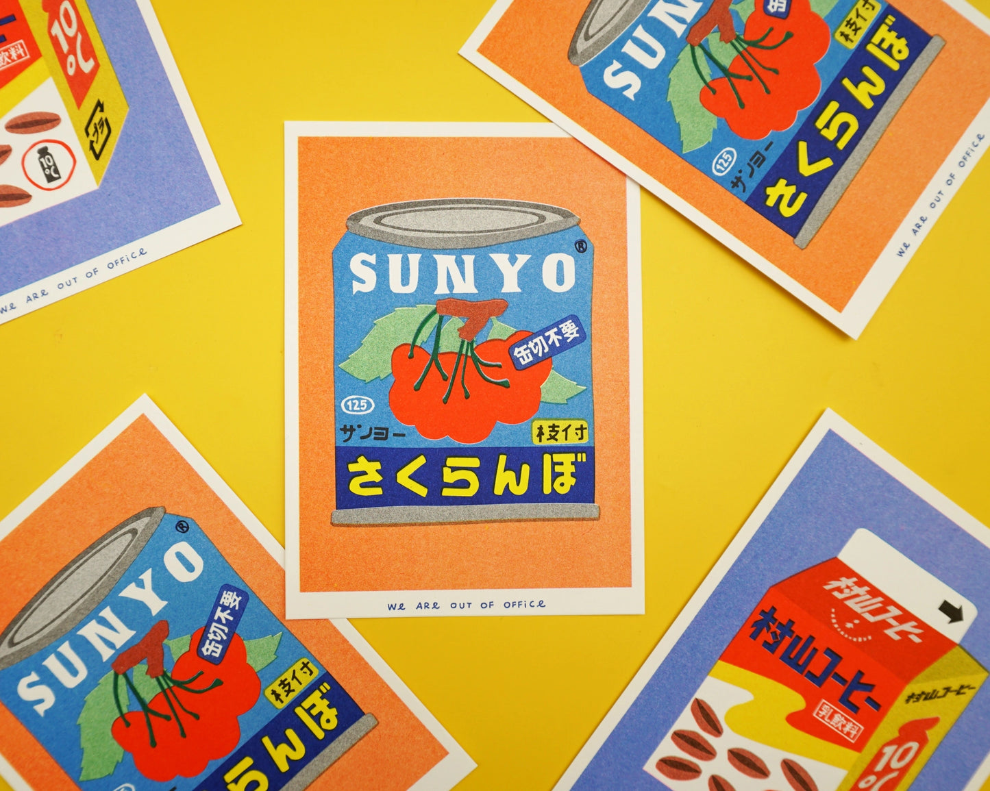 Colorful risograph art print of a Japanese can of cherries titled Canned Cherries by We Are Out Of Office, featuring bold retro typography and six-color rice-ink printing on Biotop 300g paper. Perfect wall art for pop art and Japanese design lovers.