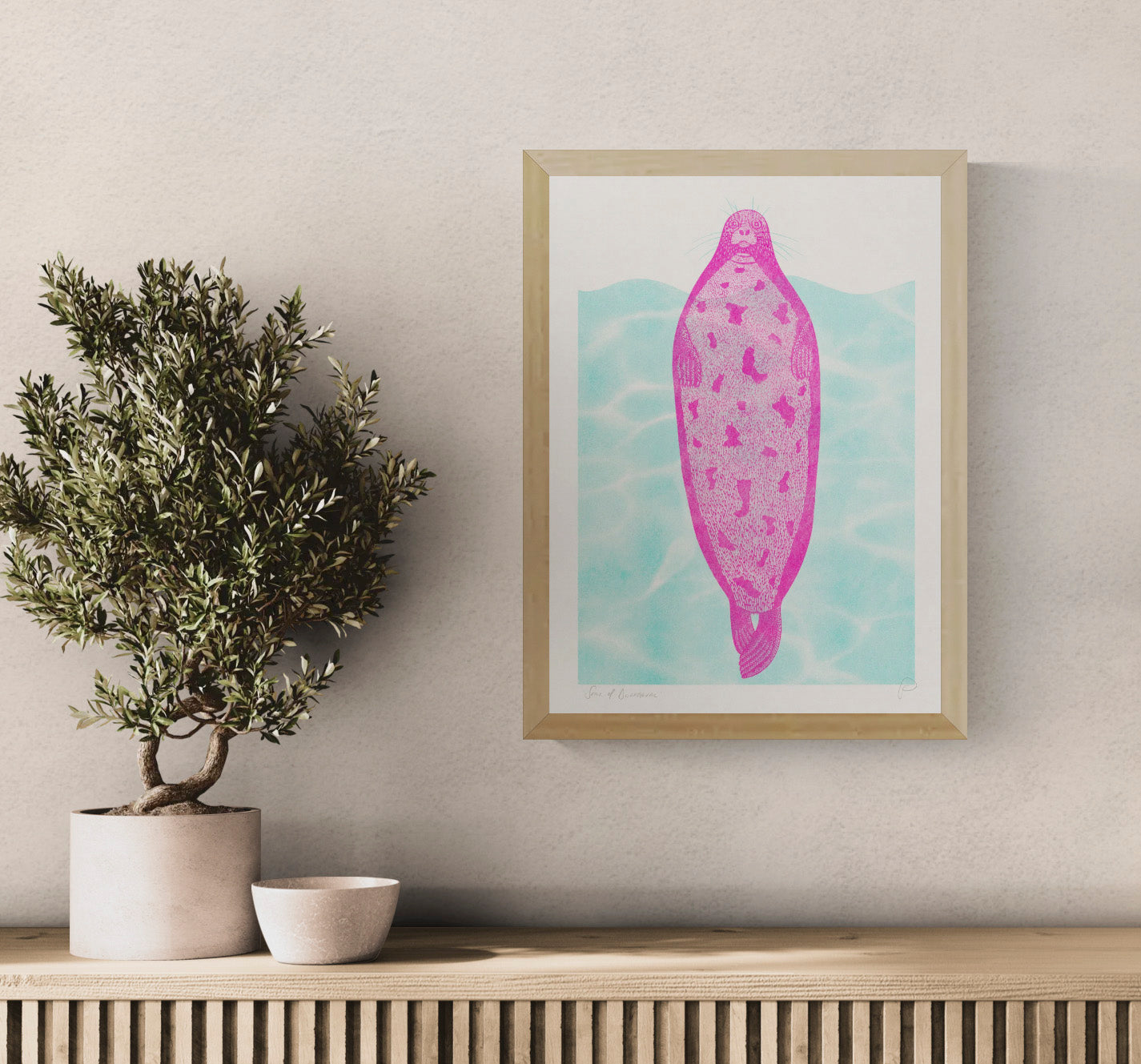 Pink seal floating against turquoise water in a playful contemporary risograph style, printed in portrait A3 format. Colourful humorous wall art for kitchens, offices and modern interiors.