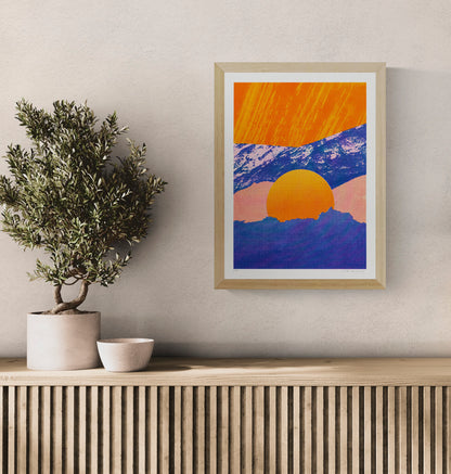 Fragments 5.0 by PTRVRKD, vertical A3 risograph print of a graphic mountain landscape with a large orange sun, deep blue peaks and soft pink tones, ideal as colourful contemporary wall art.