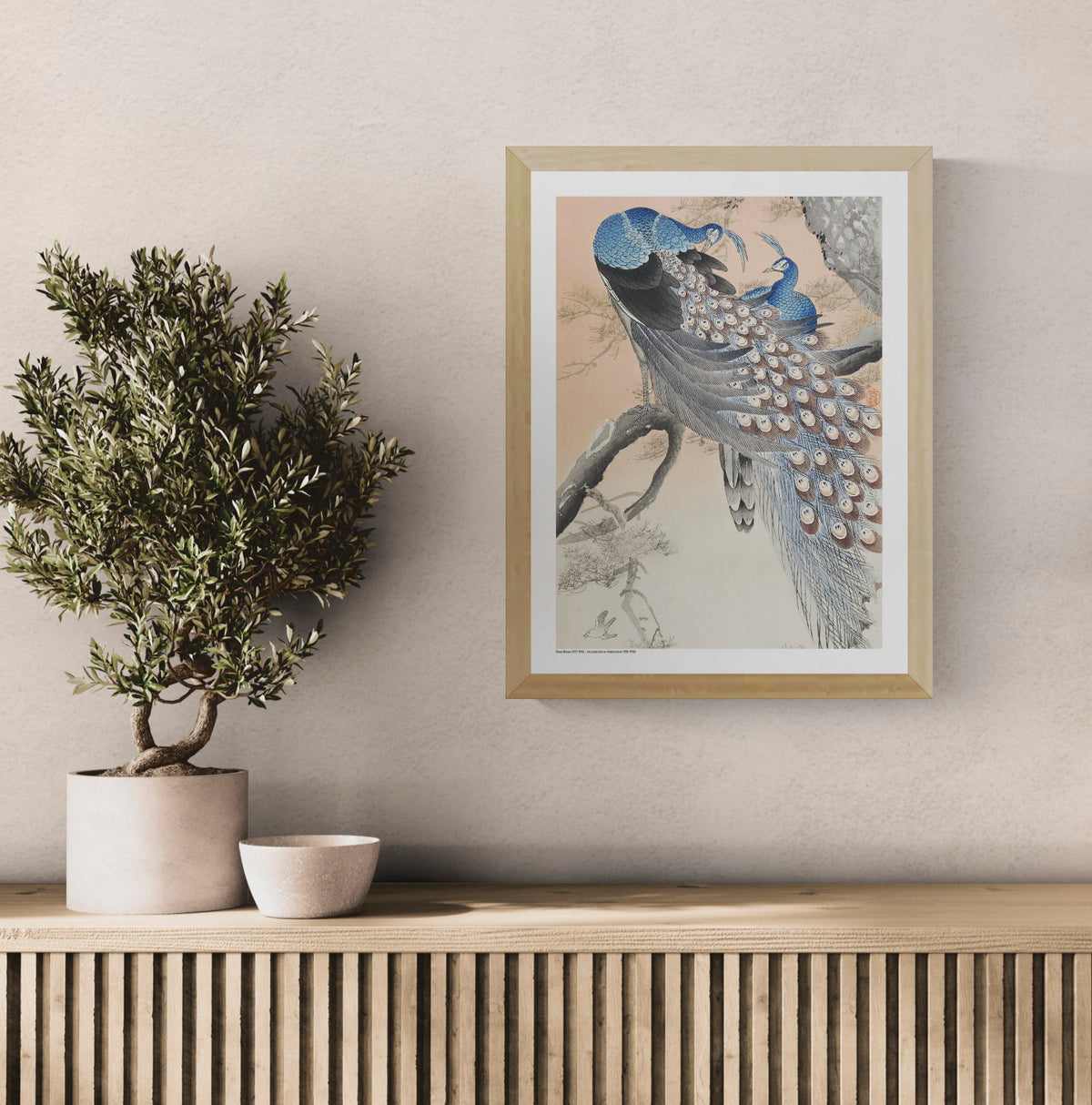 Two blue peacocks perched on a pine tree branch in a vintage Japanese woodblock style by Ohara Koson, with peach, grey and cream tones. Vertical digital art print for elegant wall decor.