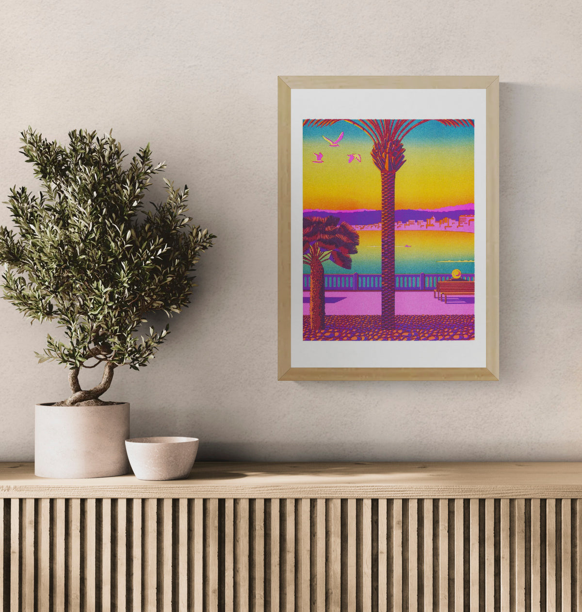 Colorful vertical Risograph print of Nice by Thomas Hayman, featuring palm trees, birds, Mediterranean sea views and a vivid pink, yellow, orange, blue and purple sunset, ideal as bright contemporary wall art.