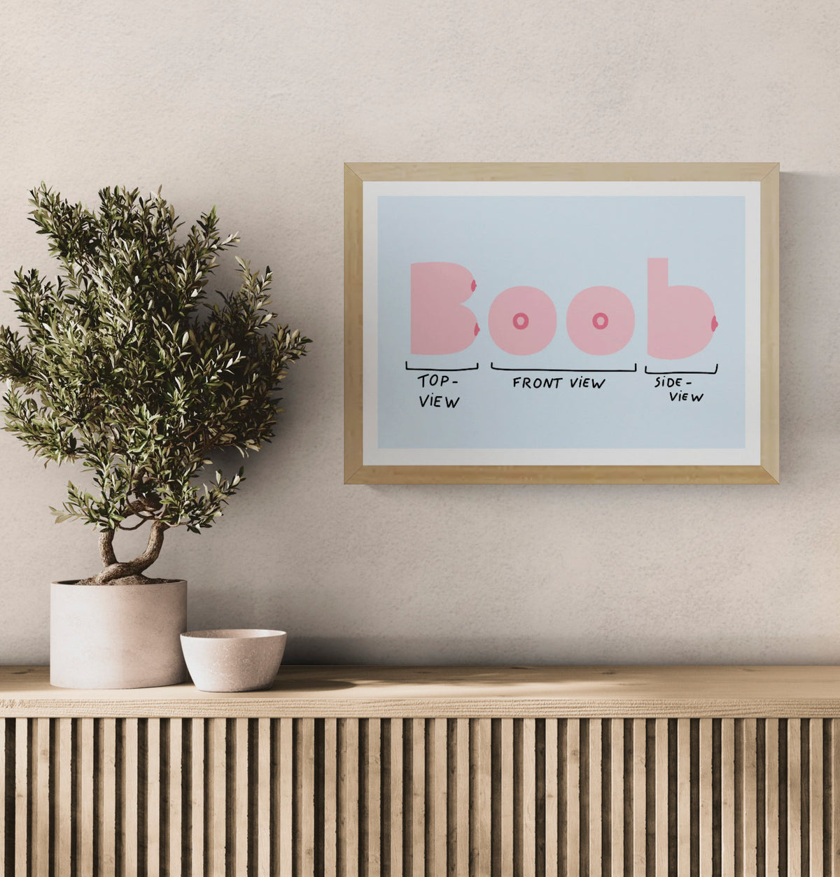 Boob View by Studio Stoutpoep, horizontal digital art print showing humorous pink breast diagrams from top, front and side views on a pale blue background, playful wall art for modern interiors.