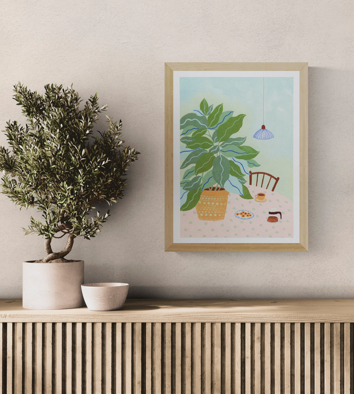 A3 illustration "Coffee Plant" by Leens showing a large leafy plant in a yellow pot, a table with a pink floral cloth, coffee cup, cookies, and carafe. Ideal for cozy kitchen or slow living decor.