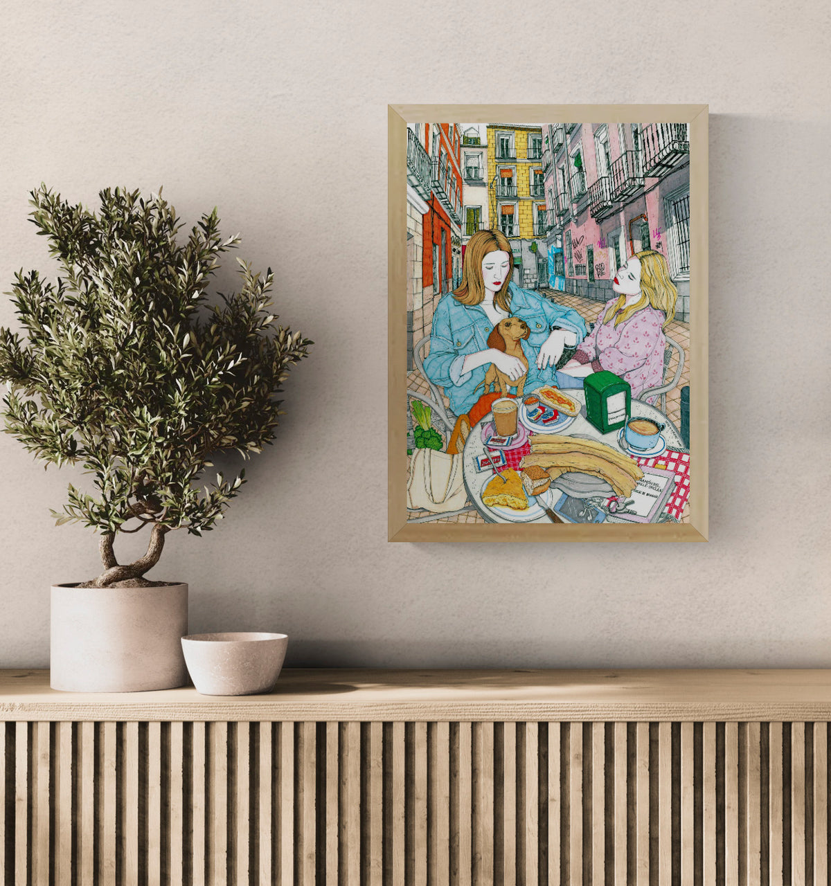 Colourful art print by Spanish illustrator Ana Jarén showing two women enjoying a typical Madrid breakfast with churros, coffee and pastries in the lively Malasaña neighbourhood – 29.7 x 42 cm, perfect wall art to bring Spanish charm to your home.