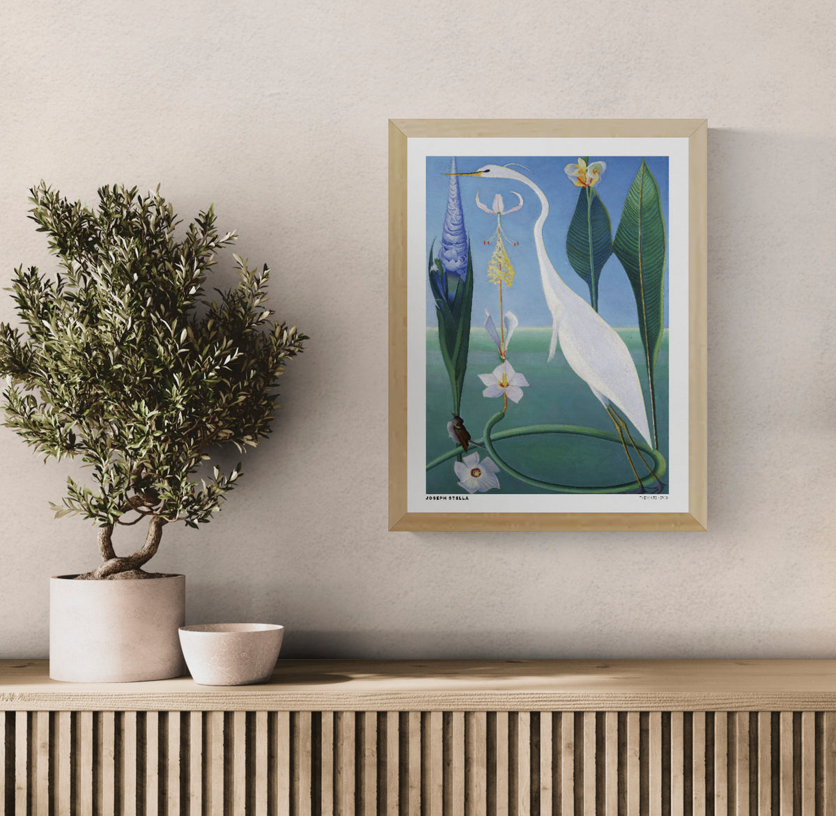 The White Heron by Joseph Stella, a vertical modernist botanical artwork featuring a graceful white heron, tropical flowers and lush green leaves against a blue background. Digital art print for nature-inspired wall decor.