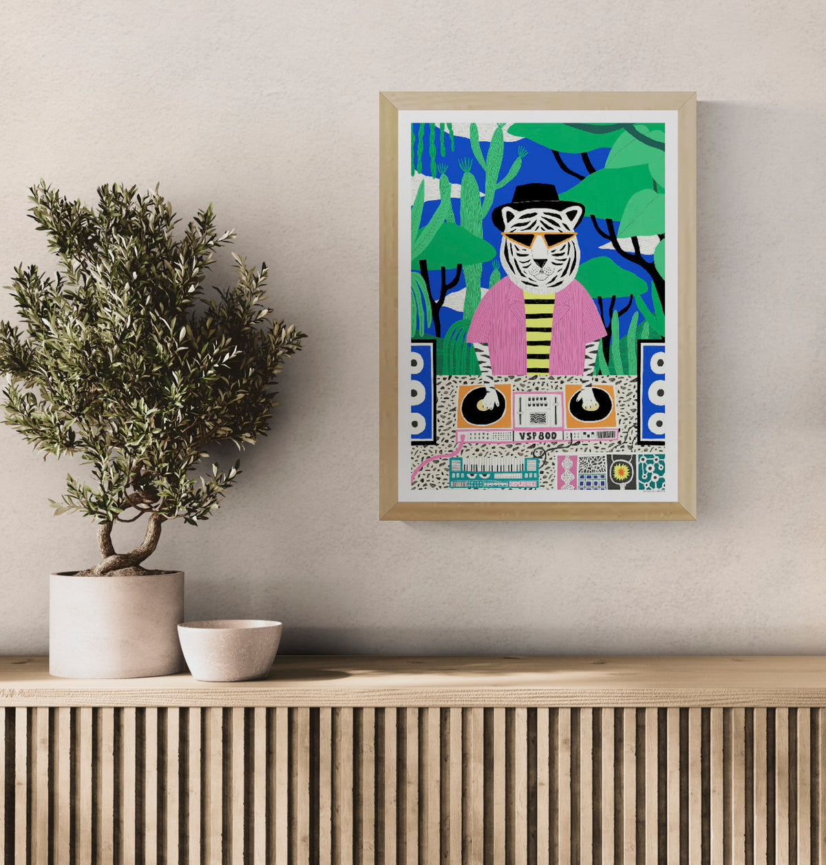 Colorful vertical giclée art print of a white tiger DJ wearing orange sunglasses, a black hat, and a pink shirt, mixing music in a green jungle with a bright blue background. Playful wall art for modern interiors.