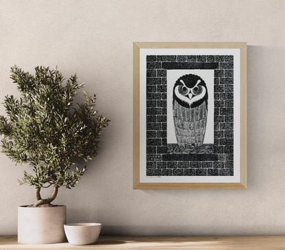 Black-and-white portrait of a wide-eyed owl framed by textured brick patterns, based on a 1914 Dutch woodcut, in vertical format for graphic wall art and study decor.
