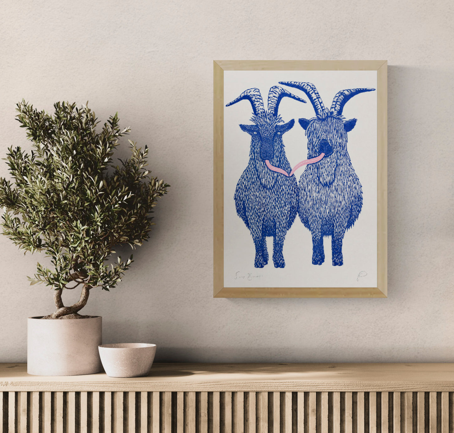 Silly Billies by Strangford, vertical A3 risograph print of two shaggy blue goats with curved horns and a playful pink tongue on cream paper, quirky wall art for colourful interiors.