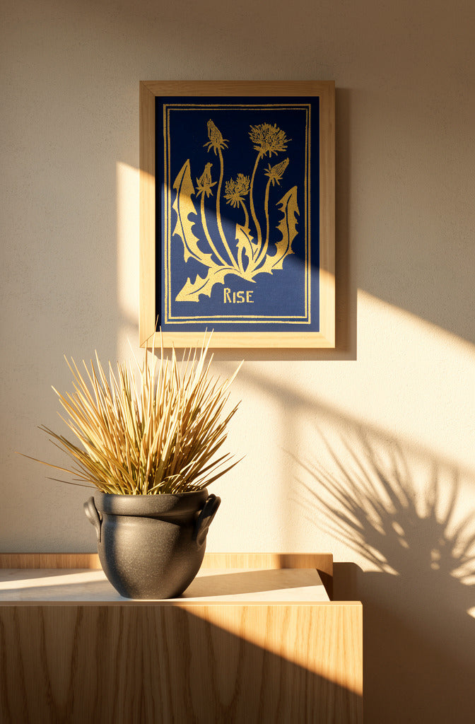 Blue and yellow handmade linocut print titled Rise by Belgian artist Leda Vaes featuring abstract dandelion flowers and organic botanical shapes on textured paper in A4 format.