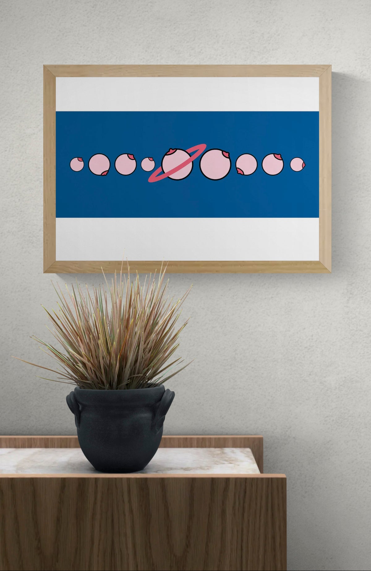 Solar by Studio Stoutpoep, horizontal digital art print showing pink illustrated breasts arranged like a solar system on a deep blue background, playful contemporary wall decor.