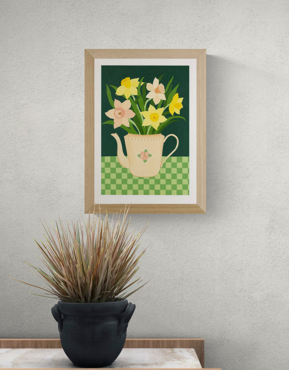 Botanical art print “Daffodils” by Leens featuring bright yellow daffodil flowers in a blue striped teapot on a pink table. Warm floral wall art with vintage colours for cozy kitchen and Scandinavian-style interiors.