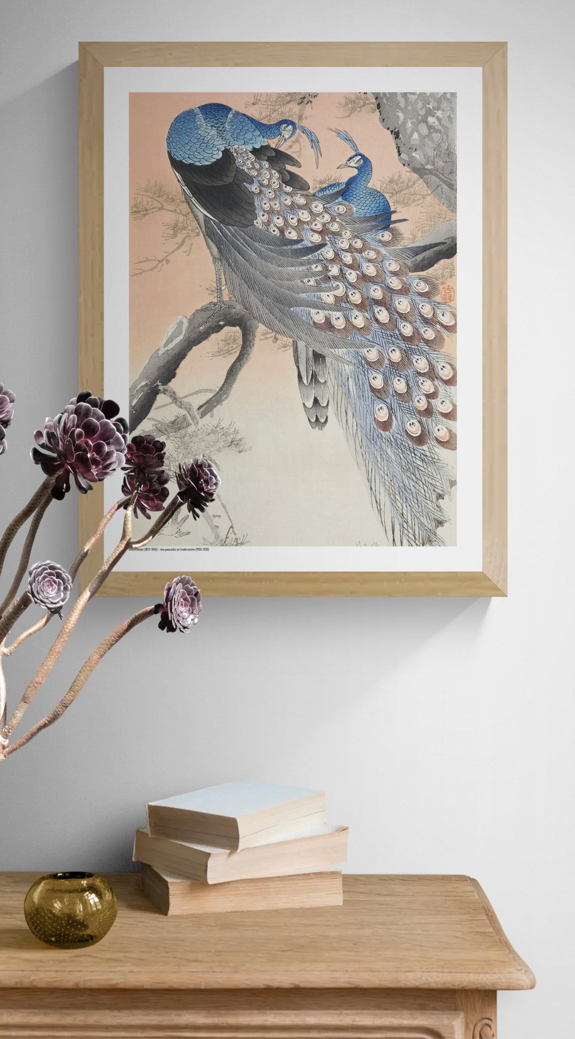 Two blue peacocks perched on a pine tree branch in a vintage Japanese woodblock style by Ohara Koson, with peach, grey and cream tones. Vertical digital art print for elegant wall decor.