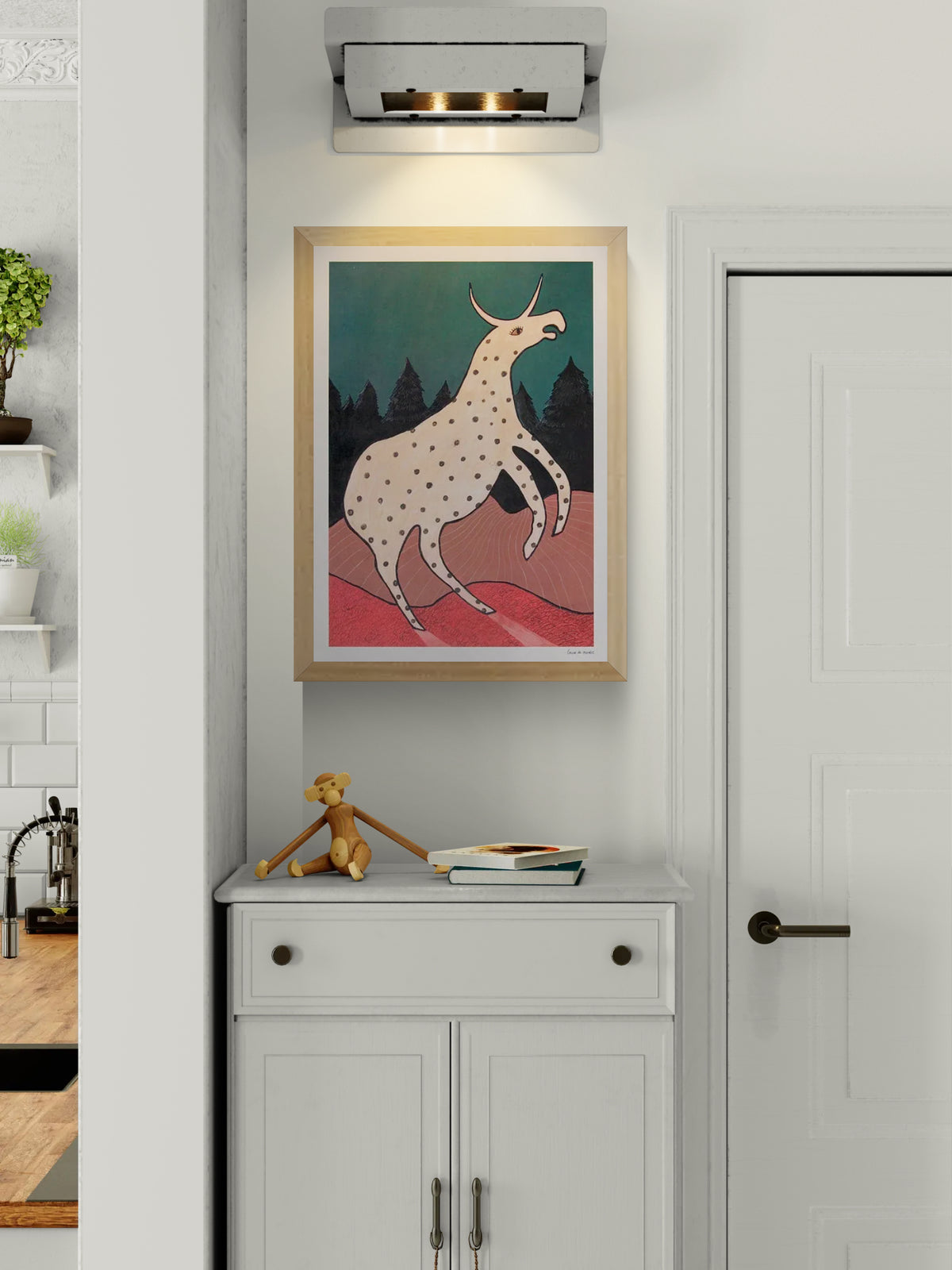 Surreal illustration titled Beest 2 by Louise de Meester, featuring a fantastical cream-colored creature with black spots and a single horn, set against a twilight forest backdrop with bold red terrain and a deep teal sky