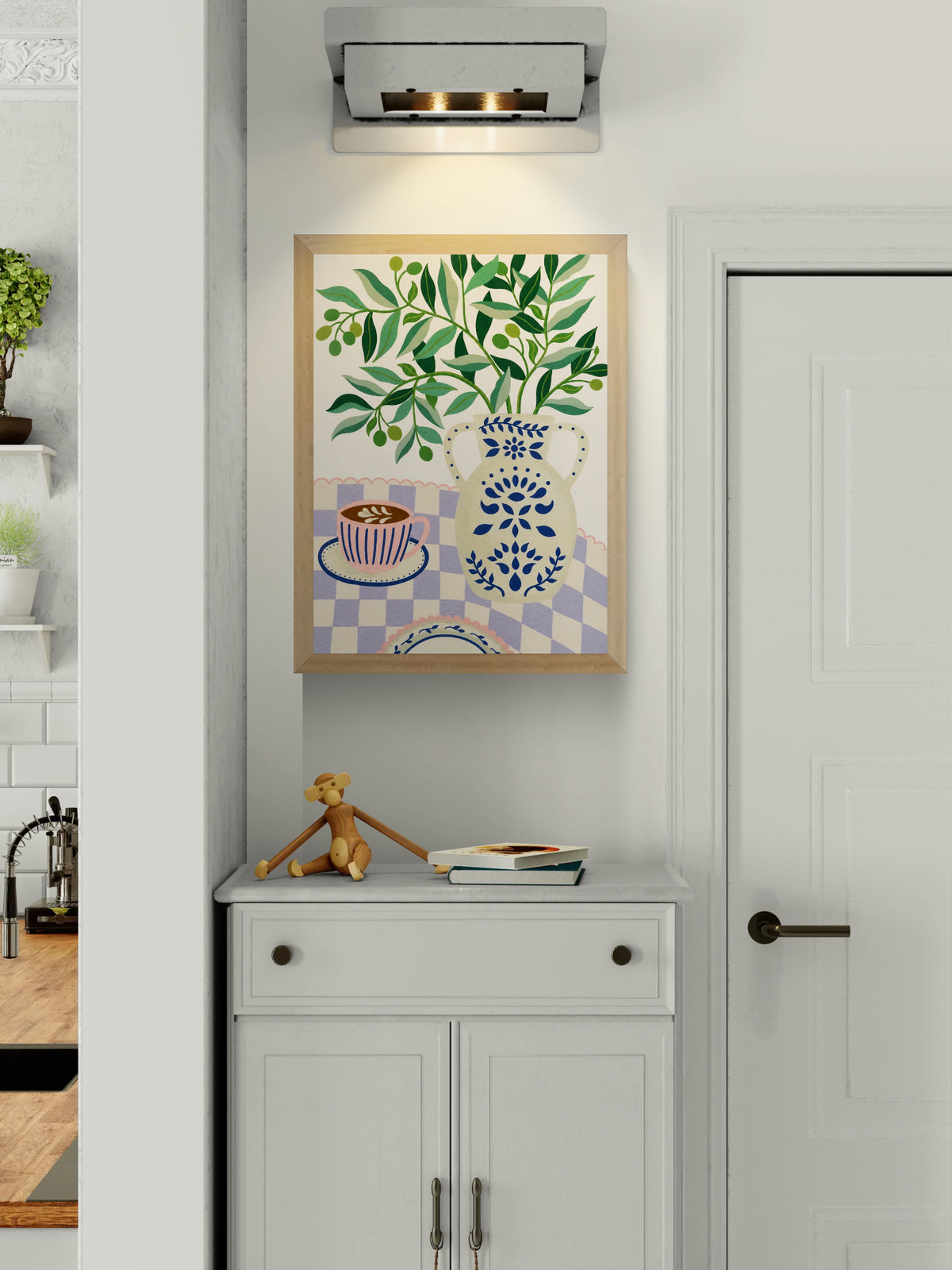 Greek Patio by Leens, colorful Mediterranean-inspired digital art print featuring olive branches in a decorative blue ceramic vase beside a pink coffee cup on a lilac checkered tablecloth, botanical wall art for cozy kitchens and modern interiors.