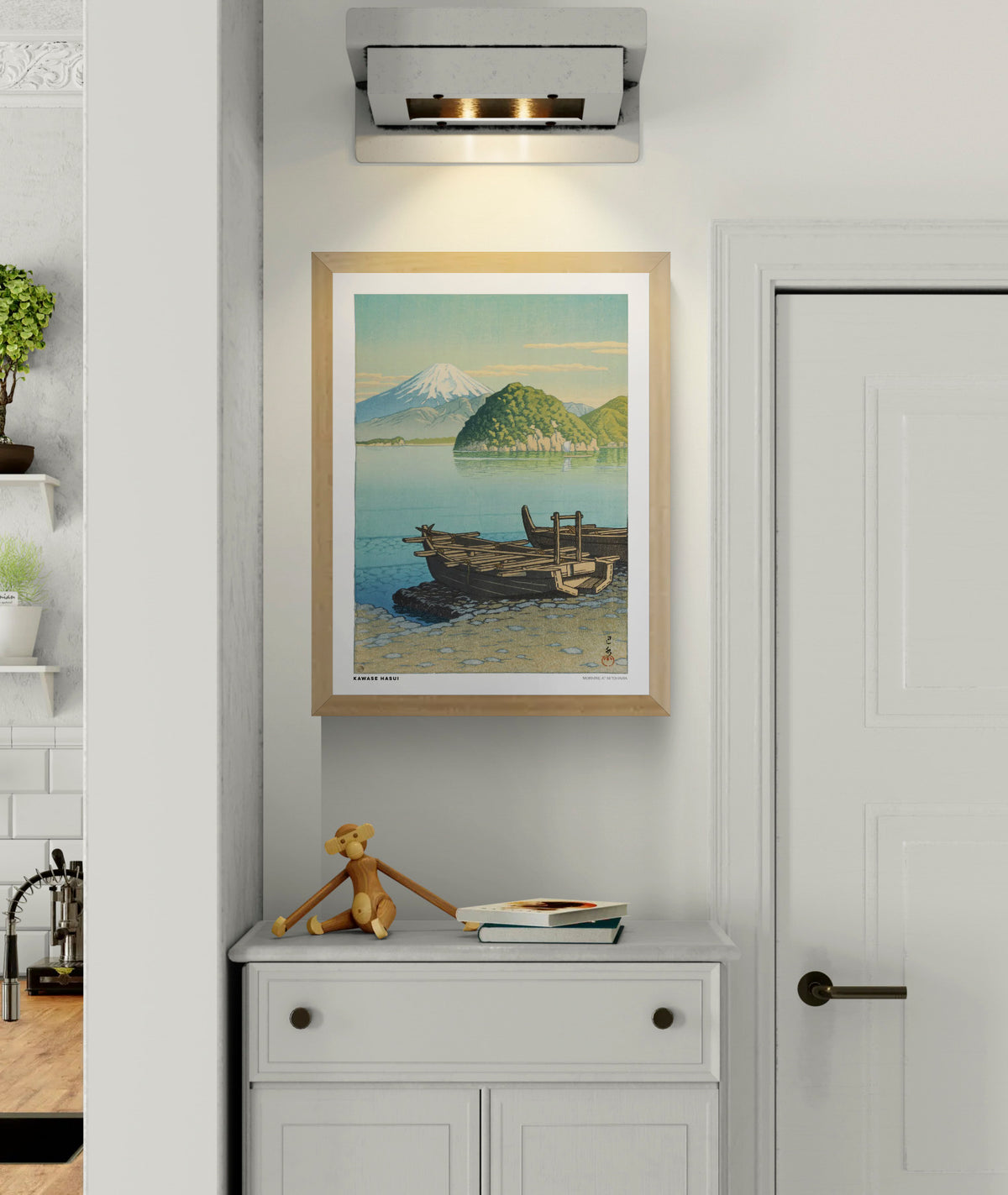 Morning in Mitohama by Kawase Hasui, a vertical Japanese landscape art print showing wooden boats on a turquoise lake, green hills and snow-capped Mount Fuji in soft blue and yellow tones. Digital print for peaceful wall decor.