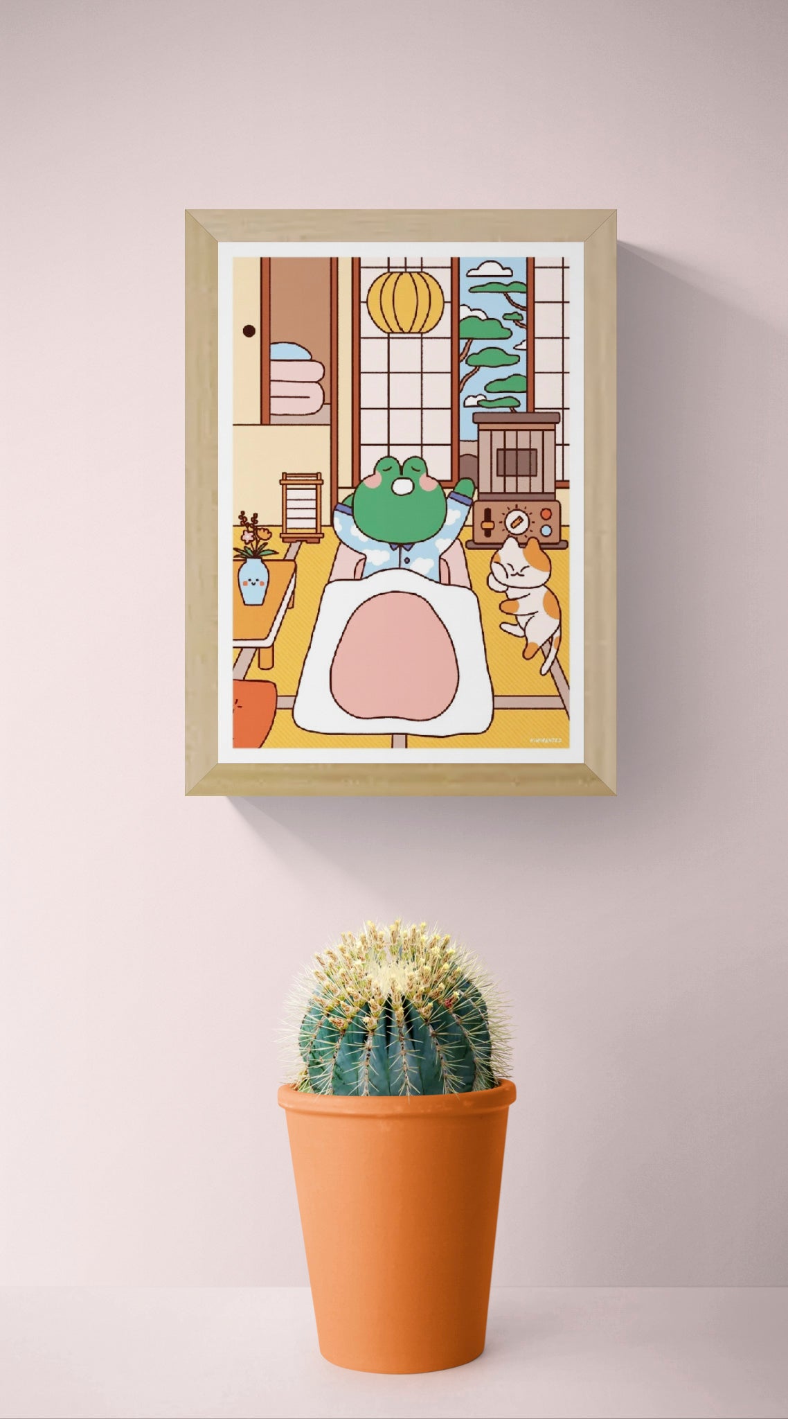 Bobby in Bed by Niniwanted, a colorful A5 digital art print featuring a cute green frog tucked into bed beside a playful cat in a Japanese-style bedroom. Kawaii wall art in soft pastel colors.