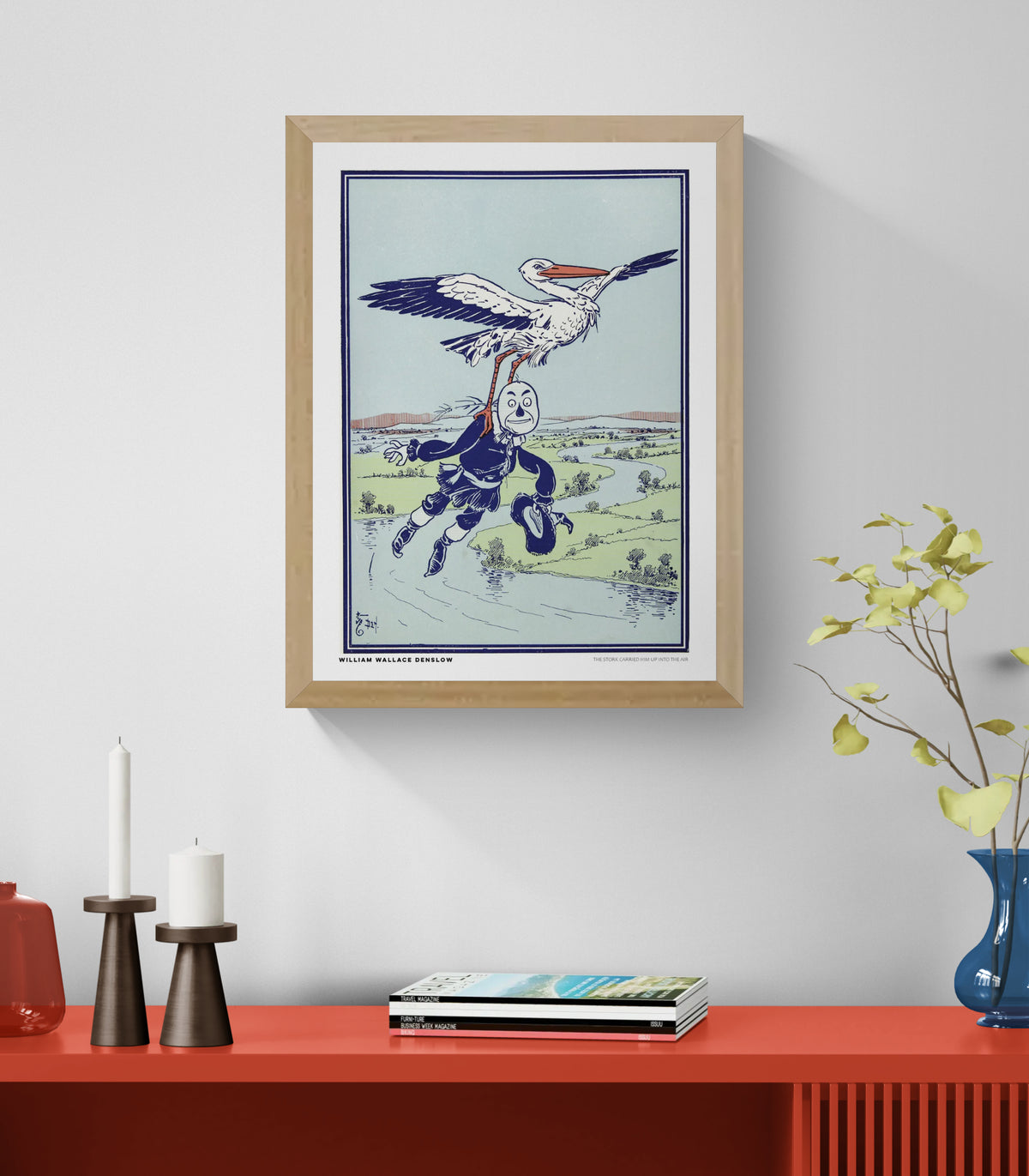 Vintage storybook illustration by William Wallace Denslow showing a large stork carrying a masked figure above a landscape, in pale blue, green, navy and orange. Vertical digital wall art print.
