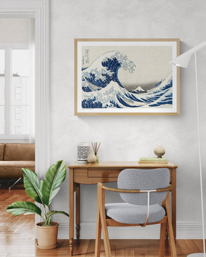Katsushika Hokusai Under The Wave art print showing towering blue ocean waves, fishing boats and Mount Fuji in classic Japanese ukiyo-e style, horizontal format for living room or office wall decor.