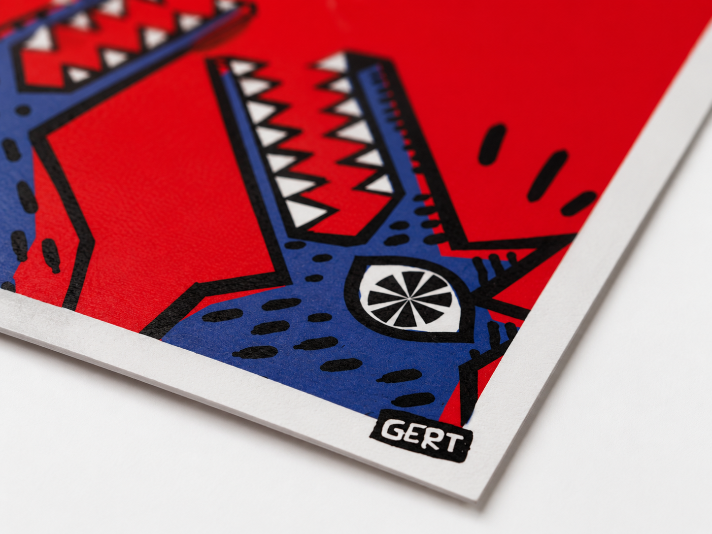 Bold contemporary art print featuring a colorful bird perched above two stylized crocodiles with open jaws, illustrated in graphic blue, red, black and white shapes. Modern digital wall art by Belgian illustrator Gert Paenen with playful humor and striking visual contrast.
