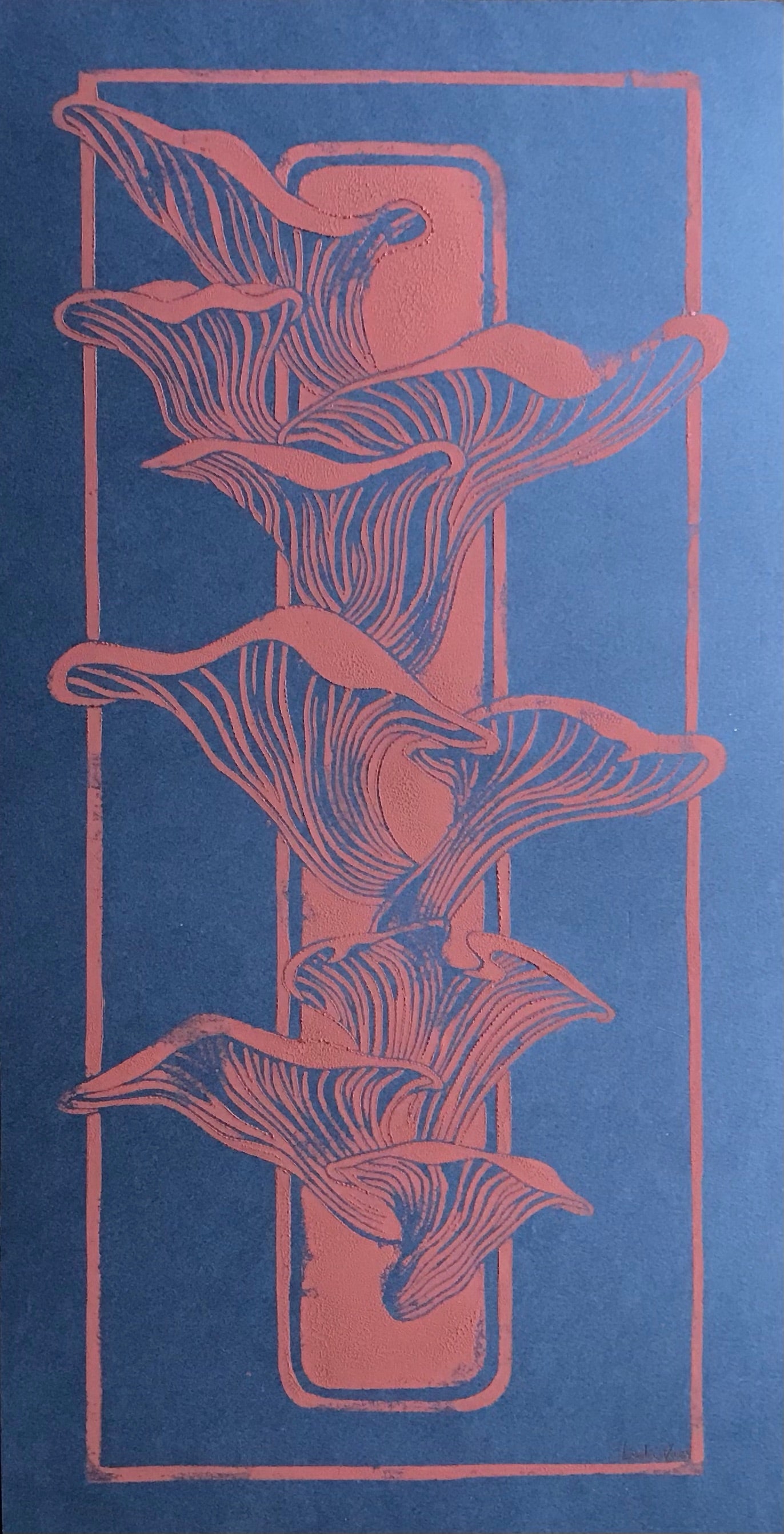 Handmade linocut print of coral-colored mushrooms growing from a piece of wood on a deep blue background; organic nature-inspired artwork, 25.5 x 50 cm by Belgian artist Leda Vaes.