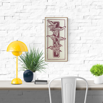 Handmade linocut print by Belgian artist Leda Vaes featuring flowing mushrooms growing on a piece of wood, carved in warm earthy tones, vertical composition, botanical natural art, minimalist organic wall decor, 25×50 cm linocut print.