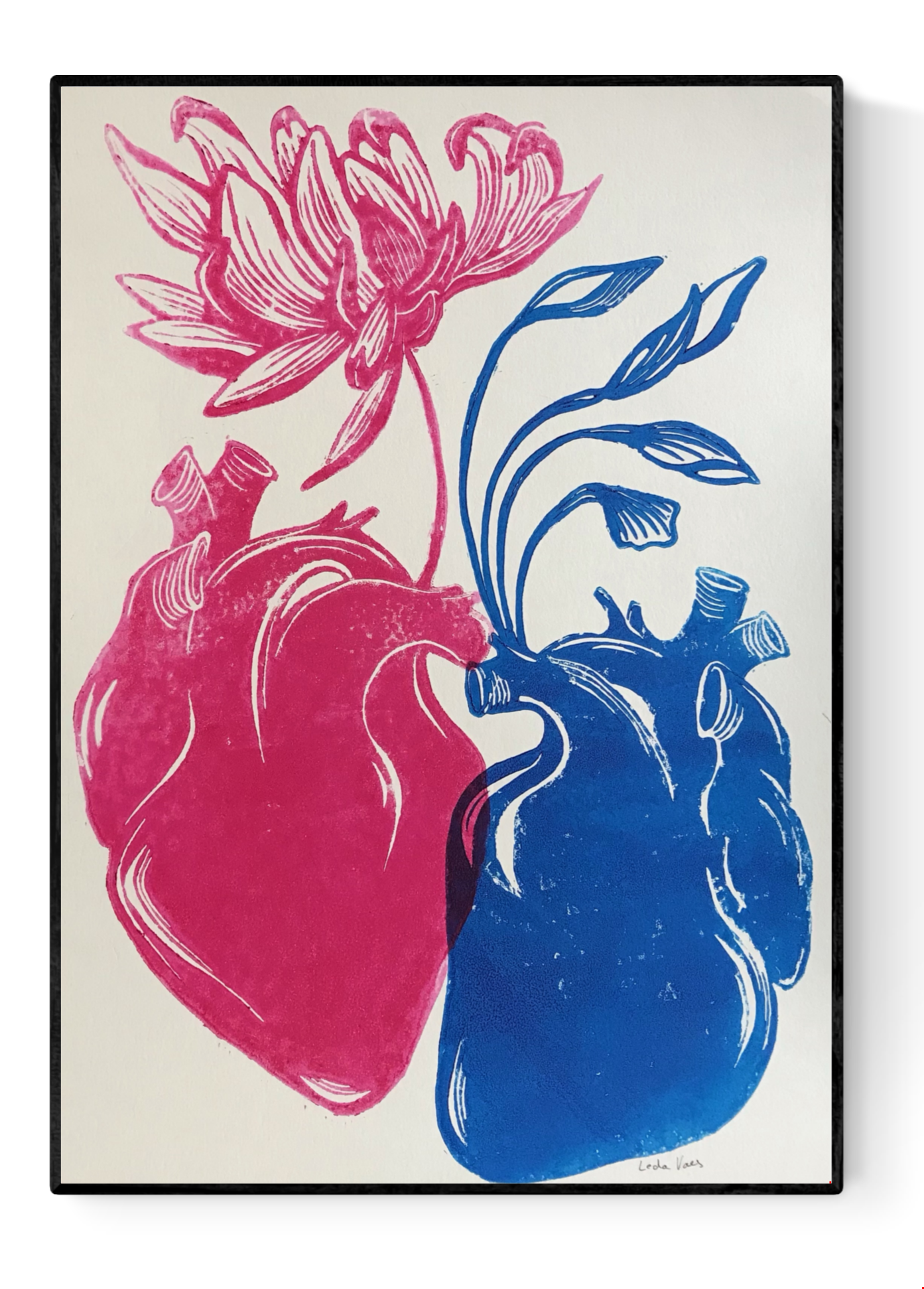 Handmade linocut print ‘Rebirth’ by Belgian artist Leda Vaes featuring a pink anatomical heart blooming into a flower and a blue heart growing flowing leaves, symbolizing renewal, connection, and new beginnings; high-contrast artistic print on textured paper.