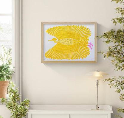 Yellow bird in flight with large patterned wings and bright pink feet, illustrated in a playful graphic style and printed as a horizontal risograph, ideal for colourful contemporary wall decor.