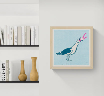 Square risograph print by Strangford showing an oversized teal and cream seagull swallowing a tiny pink swimmer against a pale blue dotted background, playful contemporary wall art for eclectic interiors.