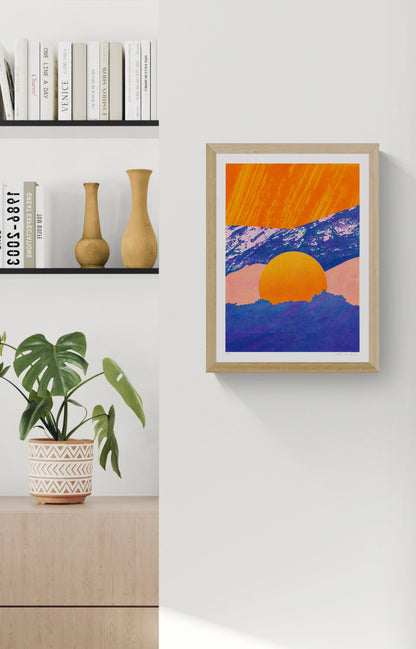 Fragments 5.0 by PTRVRKD, vertical A3 risograph print of a graphic mountain landscape with a large orange sun, deep blue peaks and soft pink tones, ideal as colourful contemporary wall art.