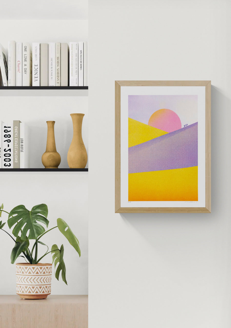Dune Landscape - Sunset by PTRVRKD, vertical risograph print with yellow and purple desert dunes, a large pink sunset and tiny walking figures, colourful contemporary wall art for modern interiors.