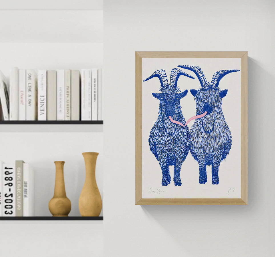 Silly Billies by Strangford, vertical A3 risograph print of two shaggy blue goats with curved horns and a playful pink tongue on cream paper, quirky wall art for colourful interiors.