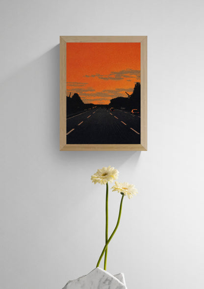 Vertical giclée art print showing cars driving along a dark motorway beneath a vivid orange sunset, with textured clouds and black tree silhouettes, ideal for modern hallway, office or gallery wall decor.