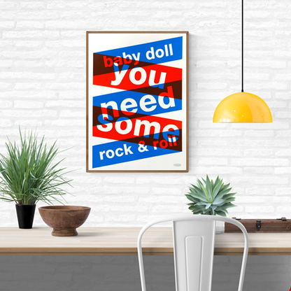 Three-color screen print ‘BABYDOLL’ by Dutch duo Gumbootz, featuring bold overlapping red, blue and grey text saying ‘baby doll you need some rock & roll,’ arranged in dynamic angled blocks on a 50×70 cm art poster; modern graphic typography artwork perfect for contemporary interiors.