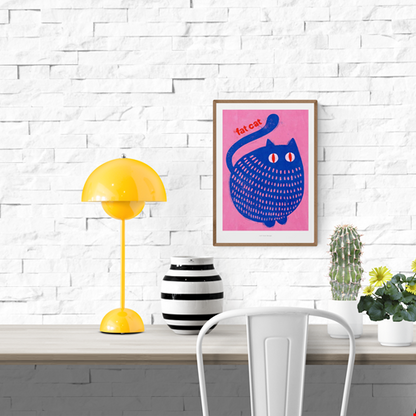 "Fat Cat" by Just Cool Design – playful and bold illustration of a chubby blue cat with red eyes on a vibrant pink background, featuring the text “fat cat”; a fun and colorful wall art print perfect for cat lovers and modern pop art enthusiasts, available at Galerie Frits