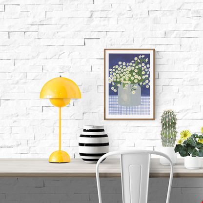 Hand-illustrated art print titled “Daisies” by Belgian artist Leens, featuring a lush bouquet of white daisies with yellow centers in a transparent jar, placed on a blue gingham tablecloth with a deep blue background. Printed on A4 textured fine art paper.