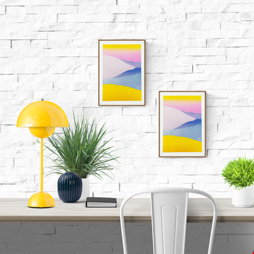Minimal pastel landscape risograph print by Dutch illustrator PTRVRKD featuring yellow sand dunes, blue hills, and a soft pink sky gradient. Handmade 12.5 x 17.5 cm art print on Biotop 250 gsm paper with soy-based inks. Ideal wall art for modern interiors, Scandinavian style, or desert-inspired home décor.