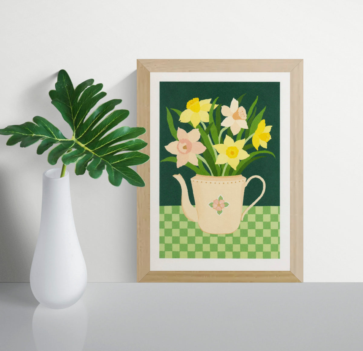 Botanical art print “Daffodils” by Leens featuring bright yellow daffodil flowers in a blue striped teapot on a pink table. Warm floral wall art with vintage colours for cozy kitchen and Scandinavian-style interiors.