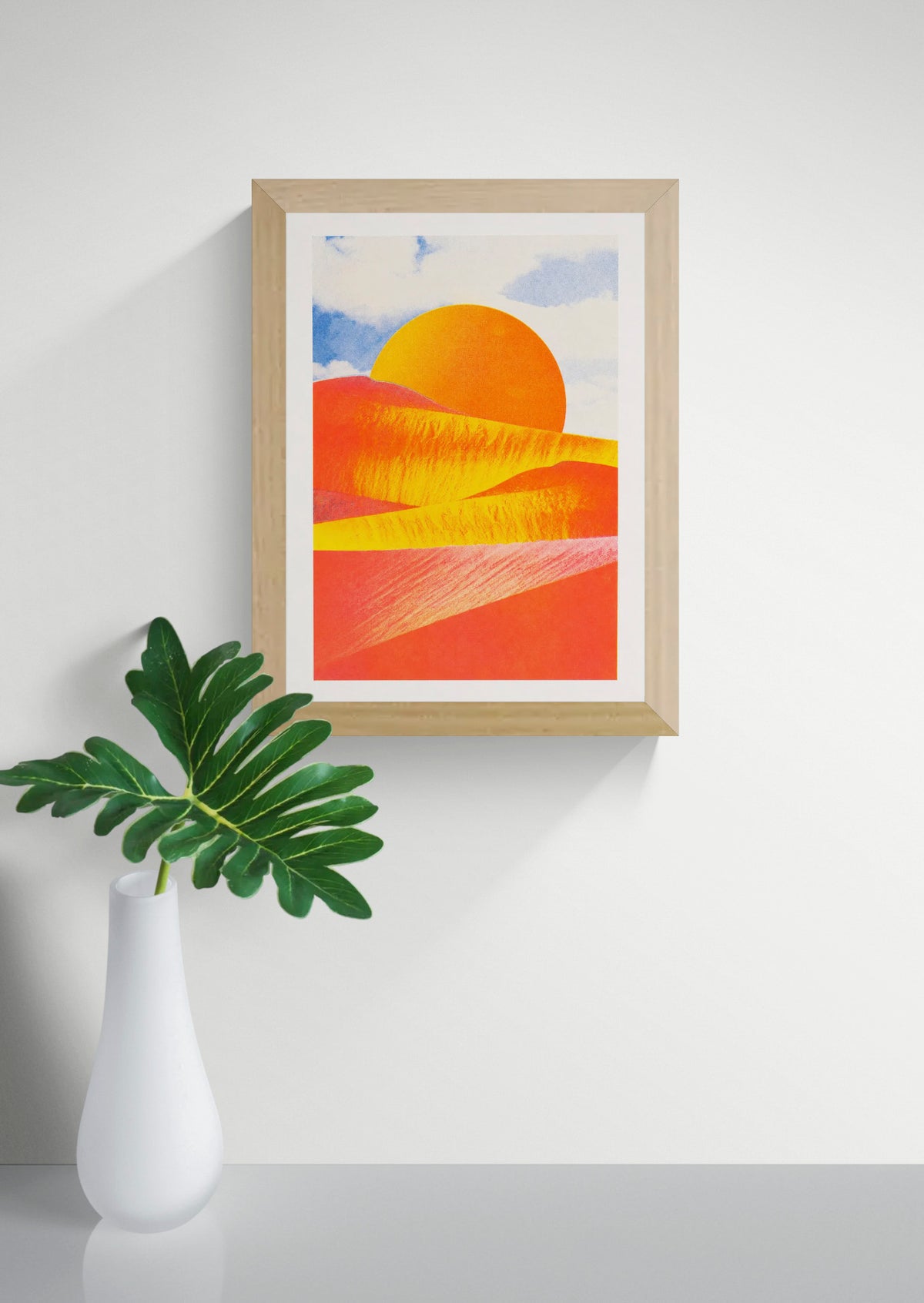 Abstract desert landscape risograph print by PTRVRKD, featuring vibrant orange and coral dunes, a golden sun, and a soft blue sky. Vertical A4 artwork for colorful modern wall decor.