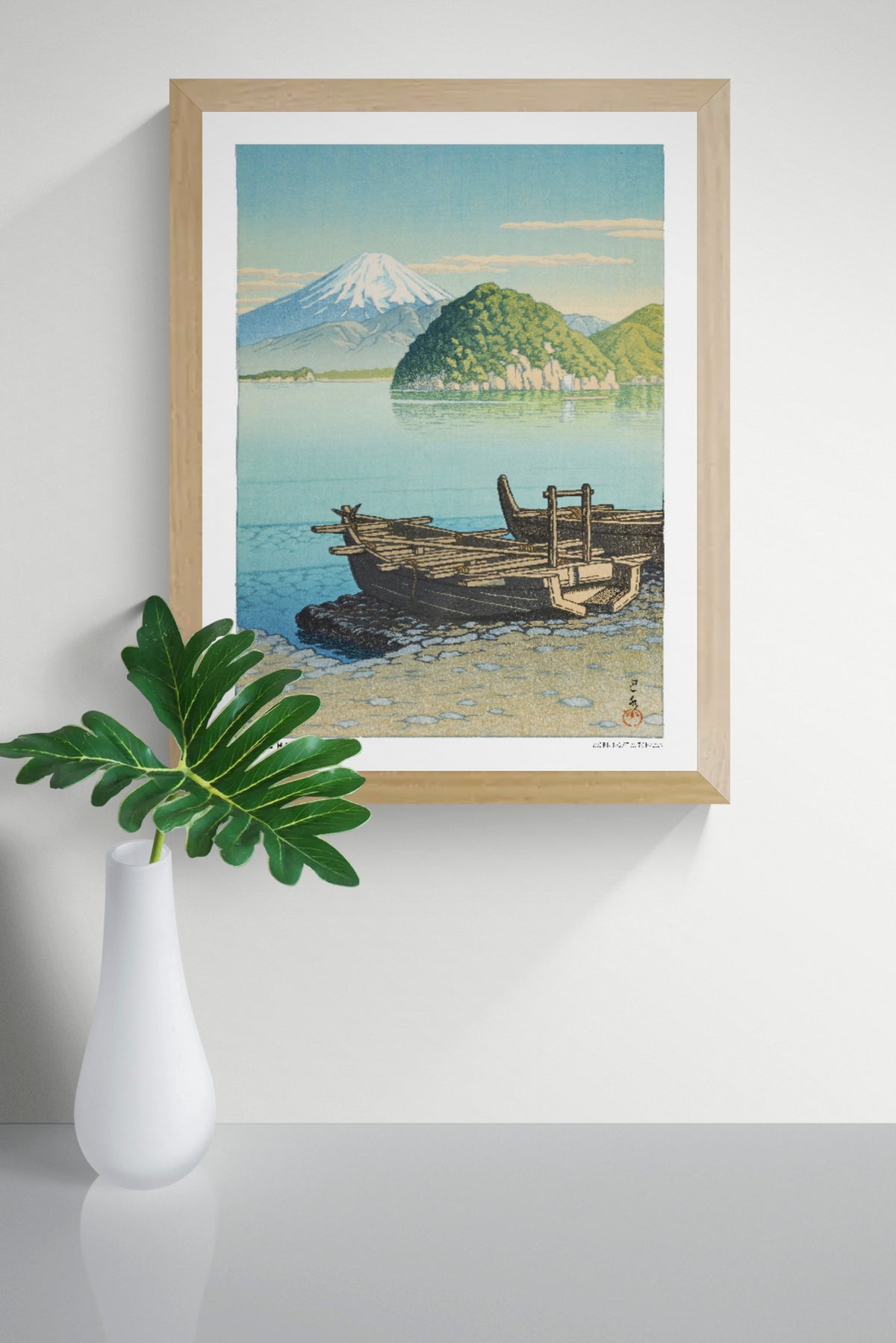 Morning in Mitohama by Kawase Hasui, a vertical Japanese landscape art print showing wooden boats on a turquoise lake, green hills and snow-capped Mount Fuji in soft blue and yellow tones. Digital print for peaceful wall decor.