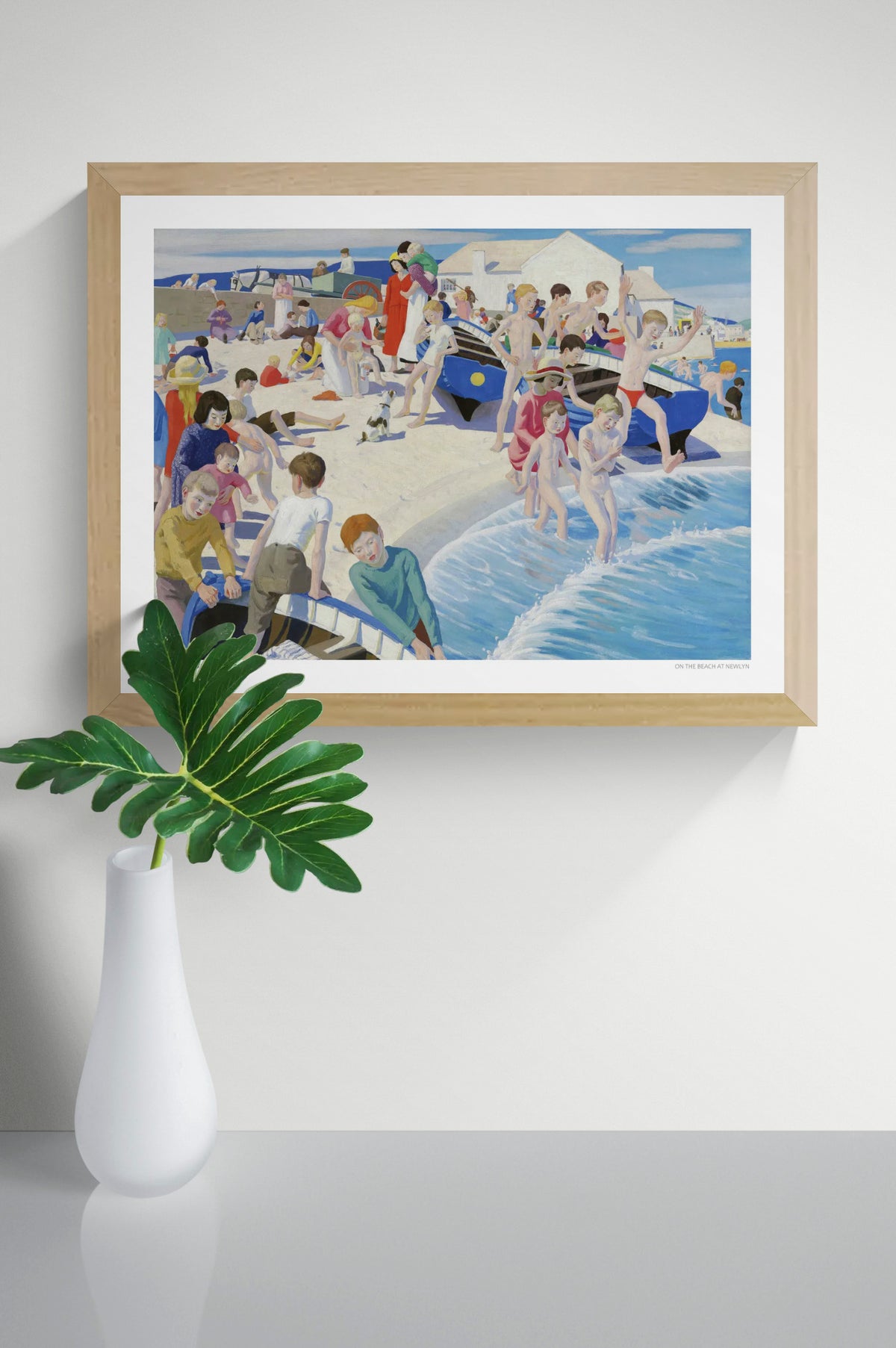 On the Beach at Newlyn by Ernest Procter, colourful British seaside painting with children swimming, families on the sand and blue fishing boats. Horizontal coastal artwork reproduced as a digital wall art print.