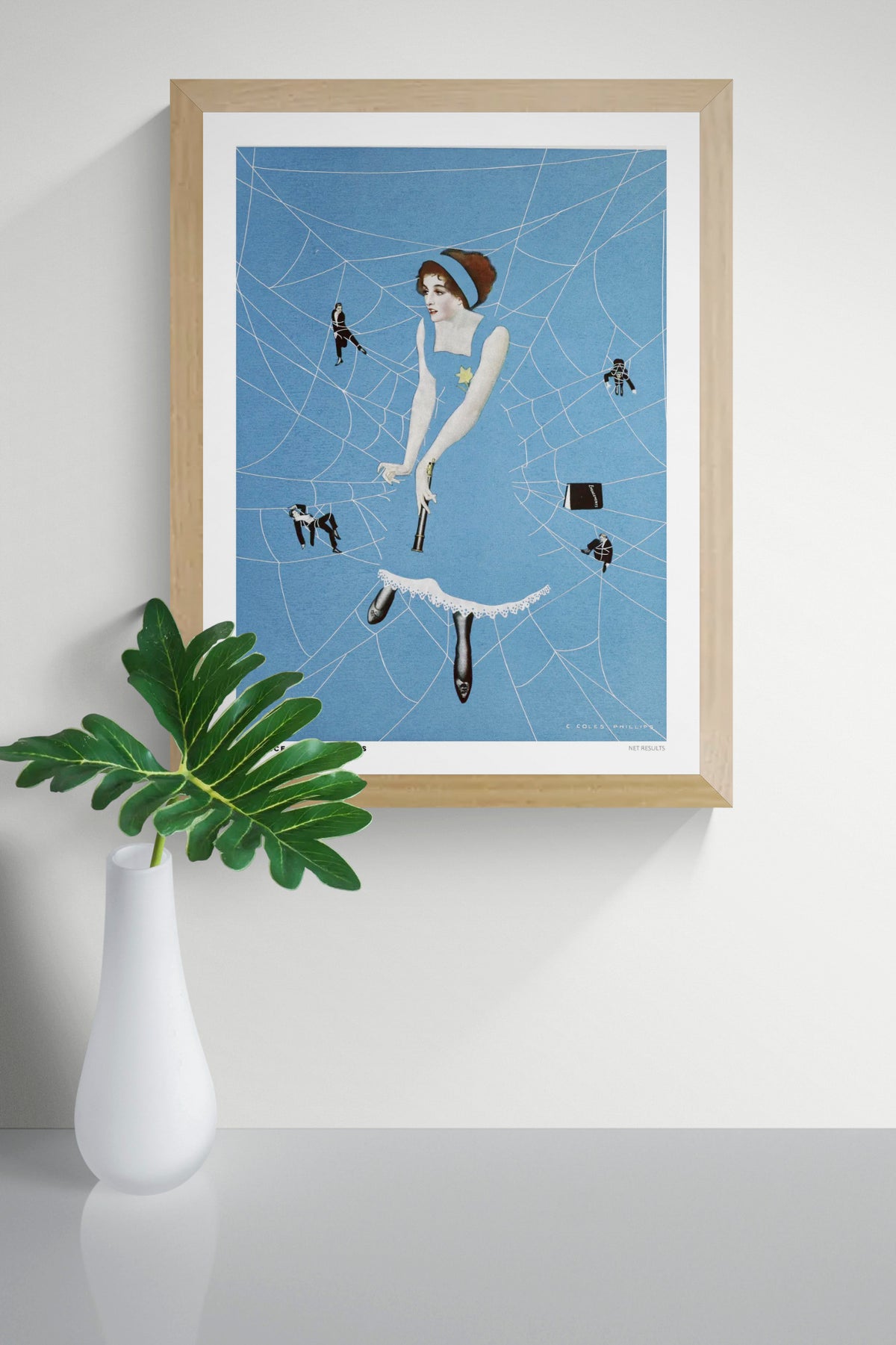 Vintage-style digital art print of Net Results by Clarence Coles Phillips, featuring a woman in a blue dress surrounded by white spiderwebs and tiny figures. Bold blue vertical artwork for eclectic wall decor.